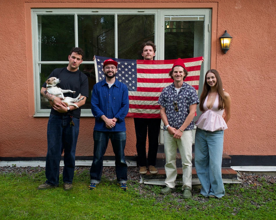 The WESN team together holding an American flag, with a dog.